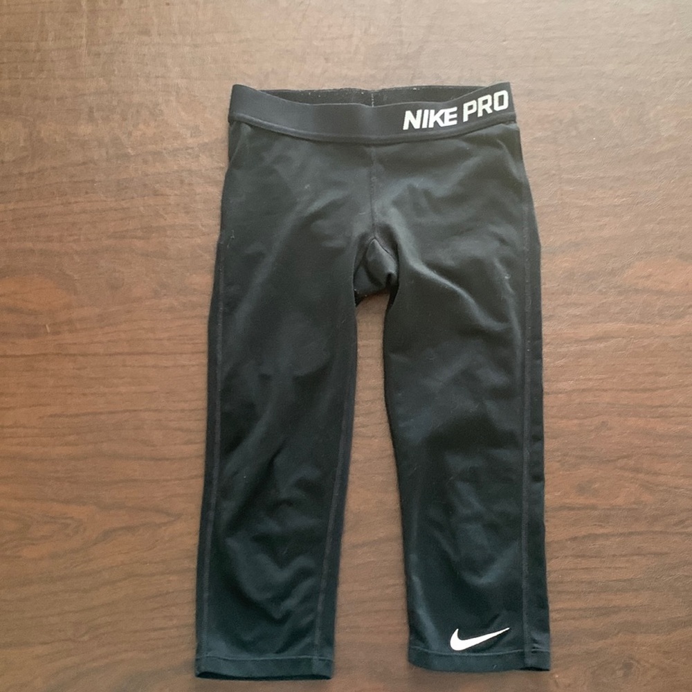 This is a black Nike cropped legging.